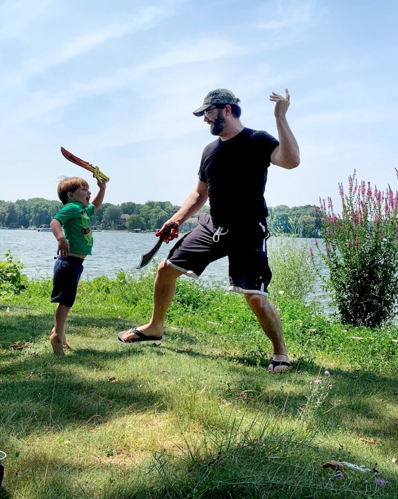 Matt play sword-fighting with his son